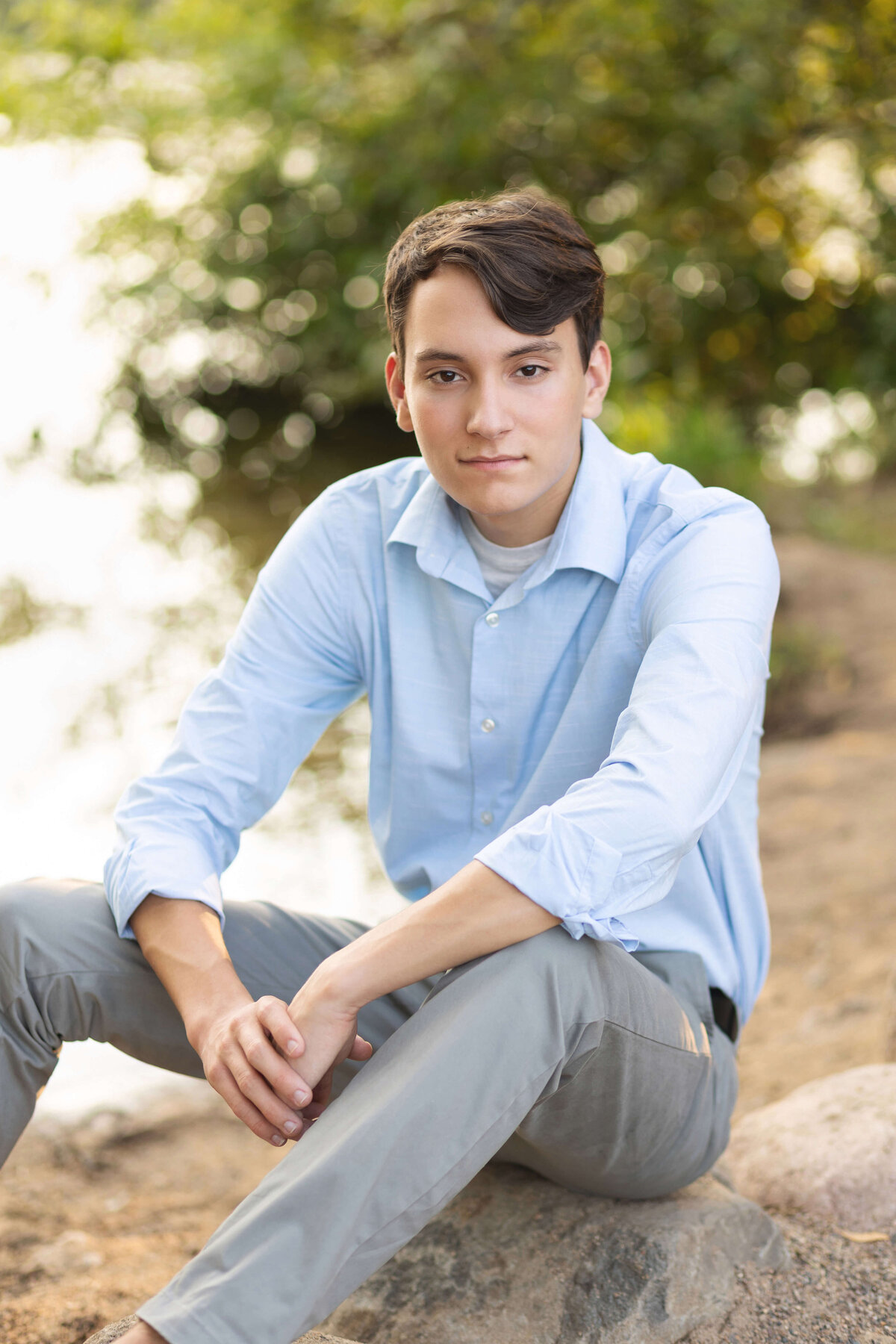 boy in blue shirt by lakeshore