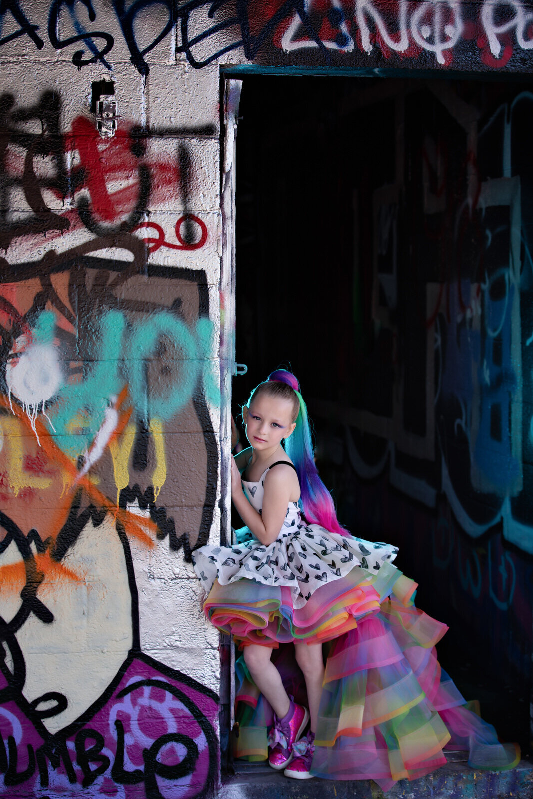 girl-in-rainbow-couture-gown-posing-in-graffiti-yard