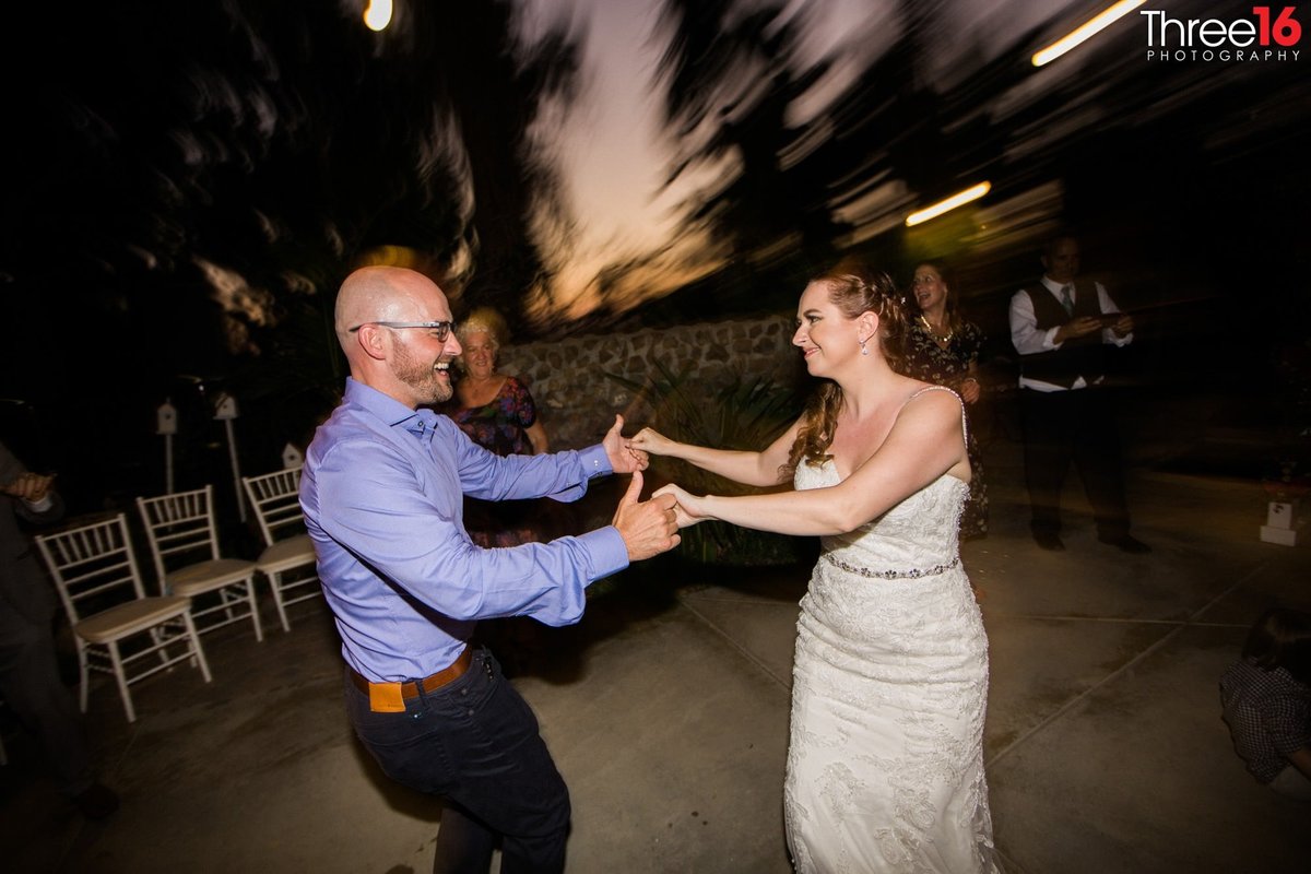 Bride dances with wedding guest at the wedding reception