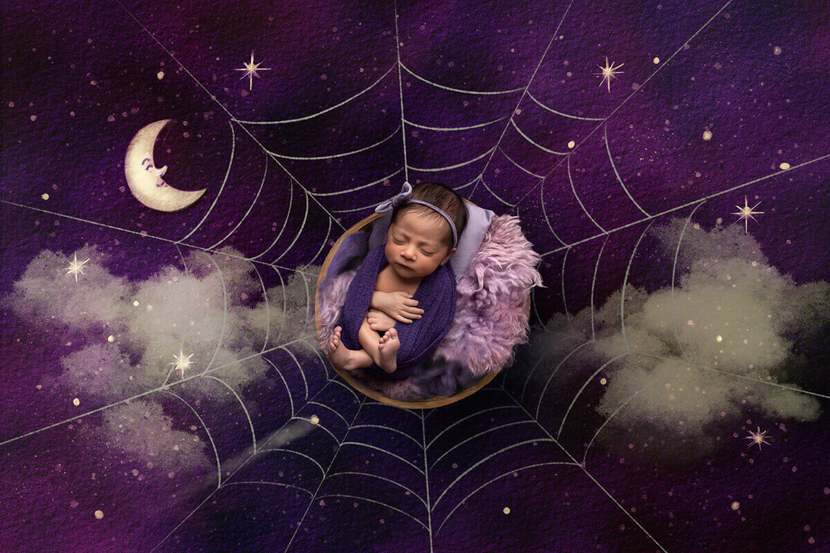 newborn baby wrapped in purple