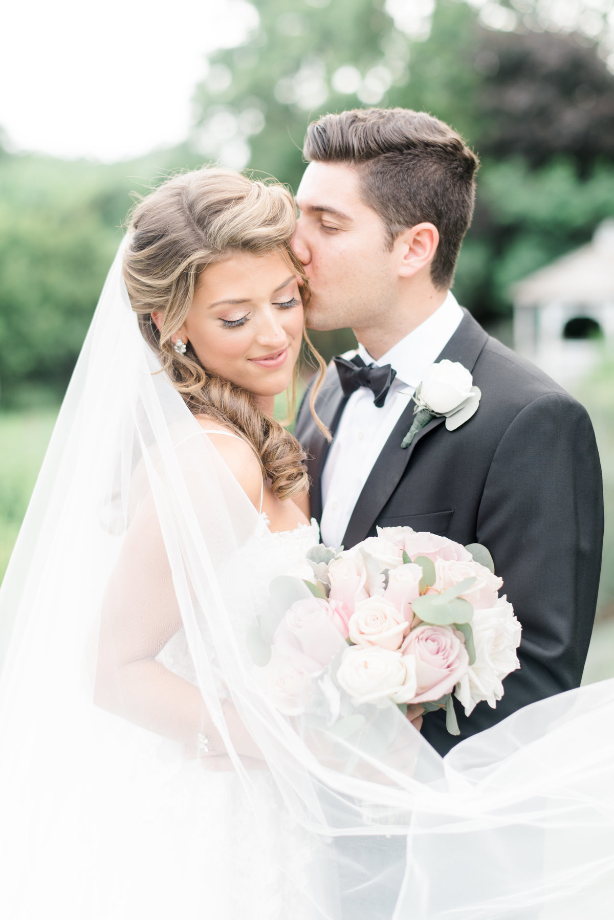 First-look-photography-groom-kissing-bride-candid-happy-bride