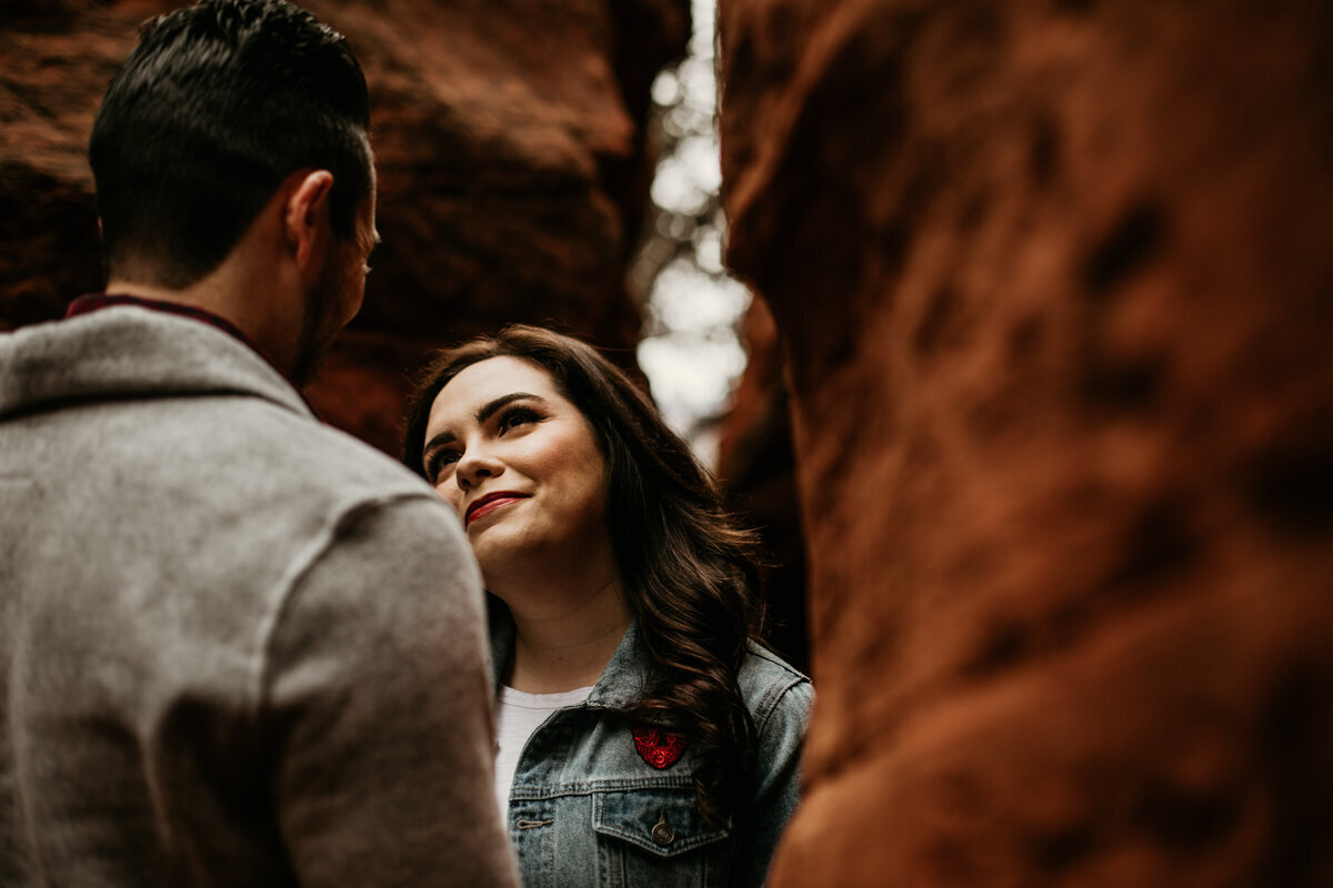 woman looking at fiancé in canyon