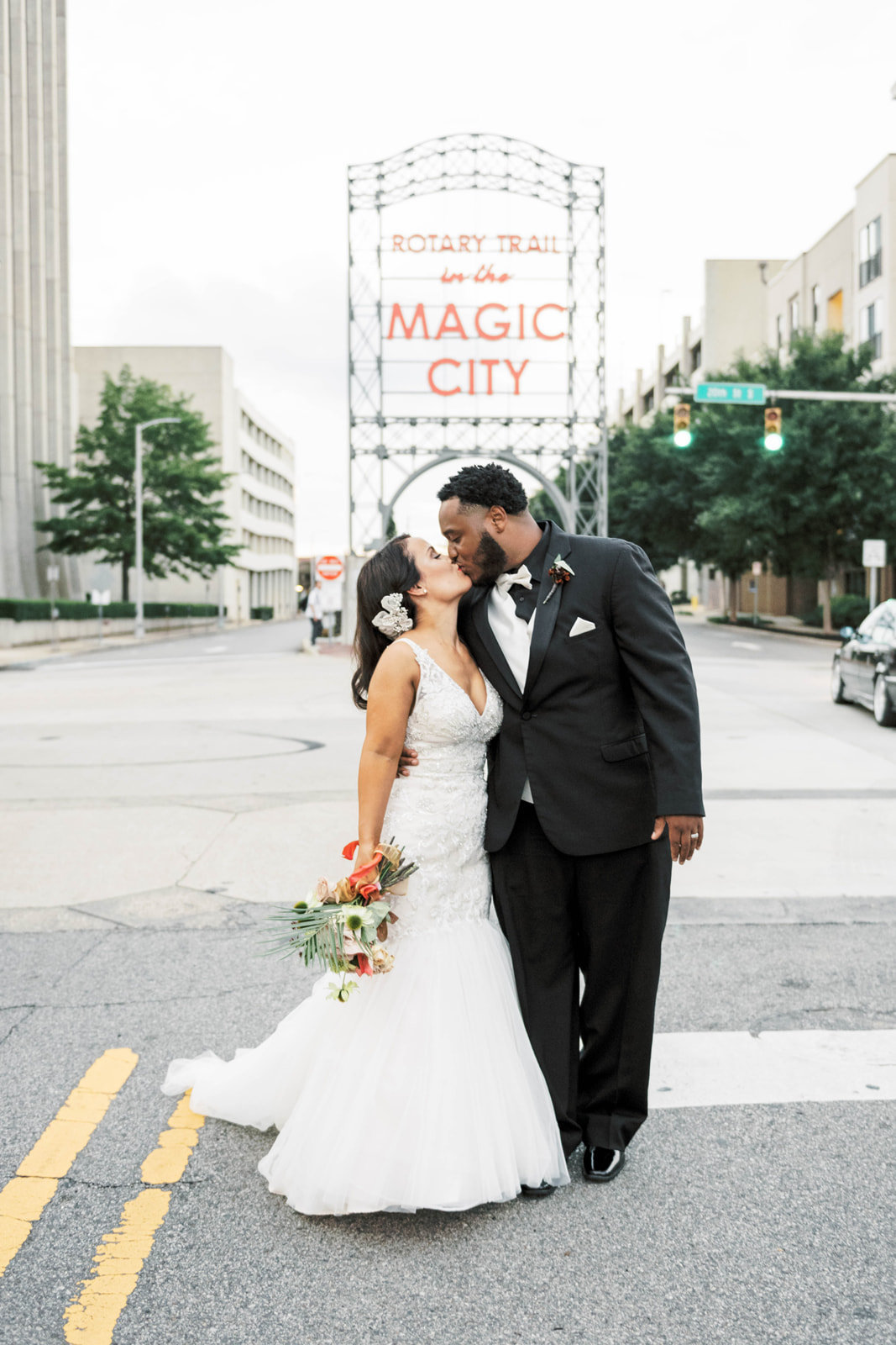 Bride and groom just married with Birmingham Magic City sign downtown