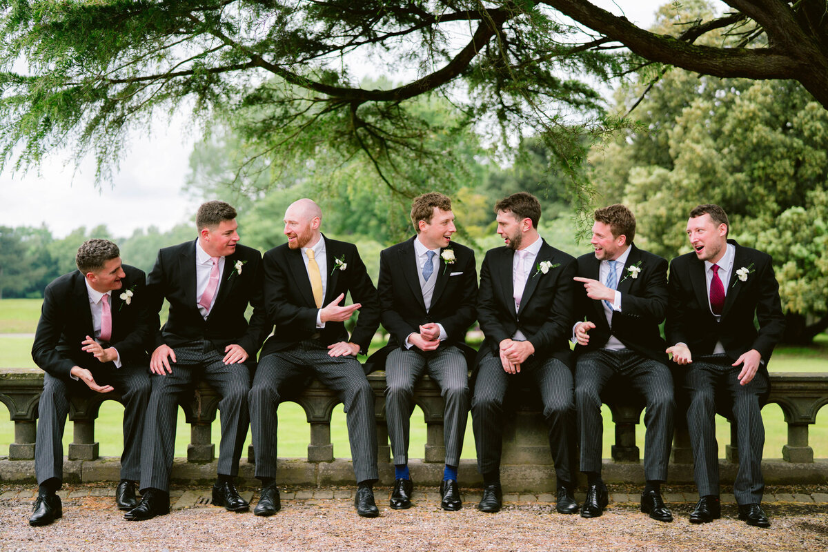 groomsmen sat on the wall at capesthorne hall
