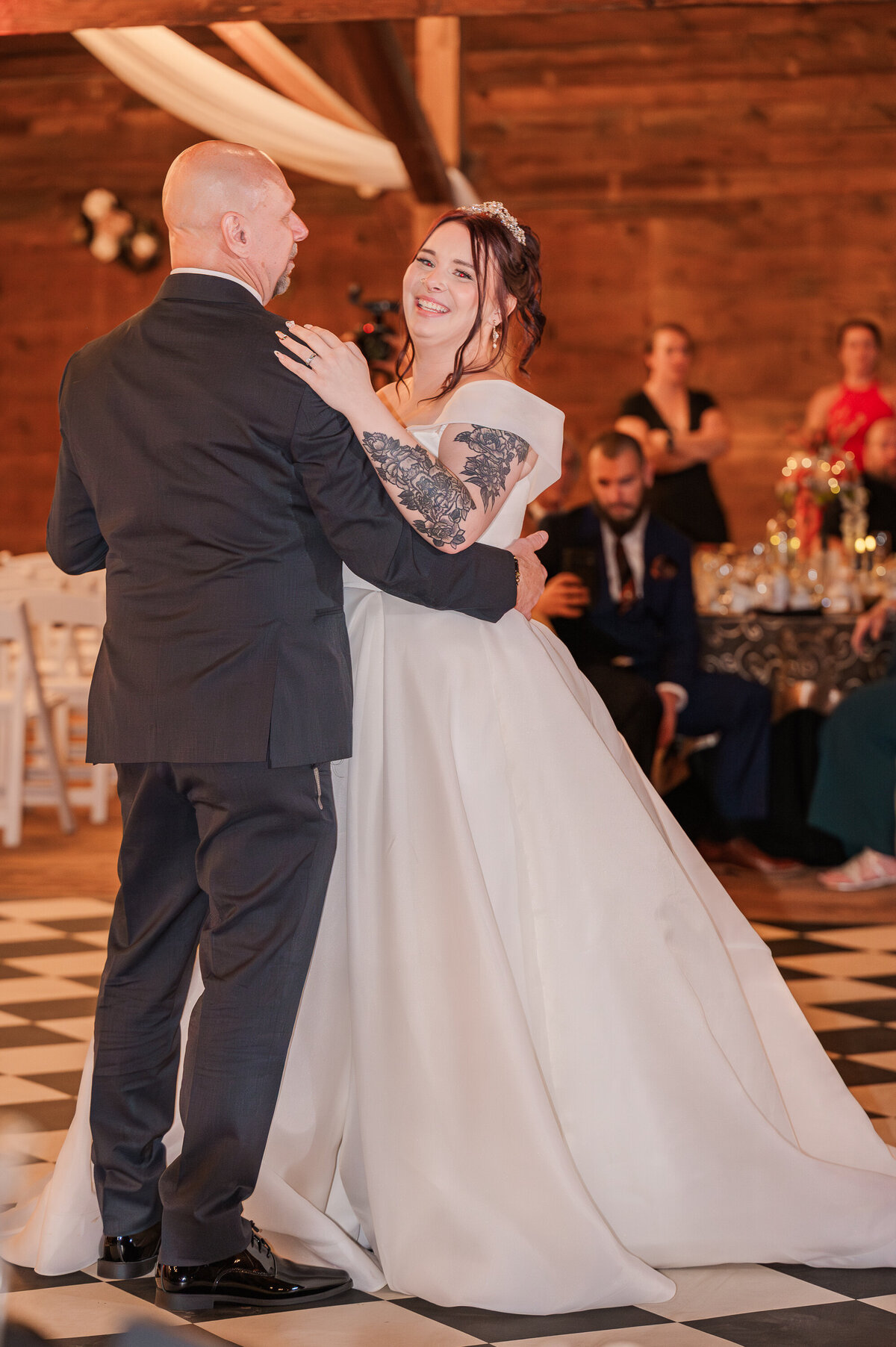 The father of the bride dancing with his daughter at her wedding reception by Raleigh wedding photographer, JoLynn Photography