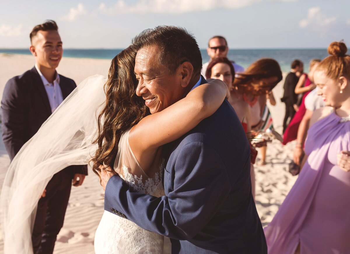 Bride hugging father after wedding in Cancun