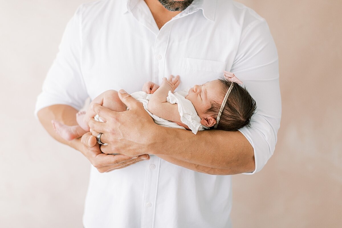 Dad holding baby girl in his arms