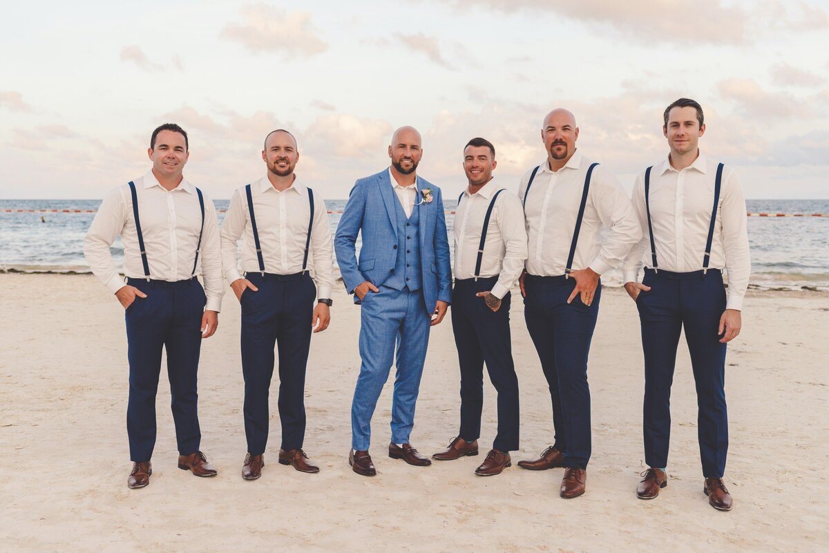 Groomsmen on beach at wedding in Riviera Maya