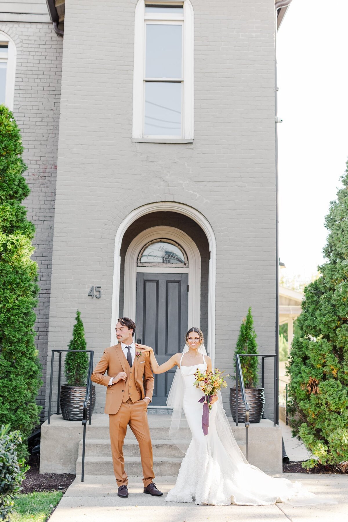 Bride and groom dramatically posing together in front of the Cordelle in Nashville, TN