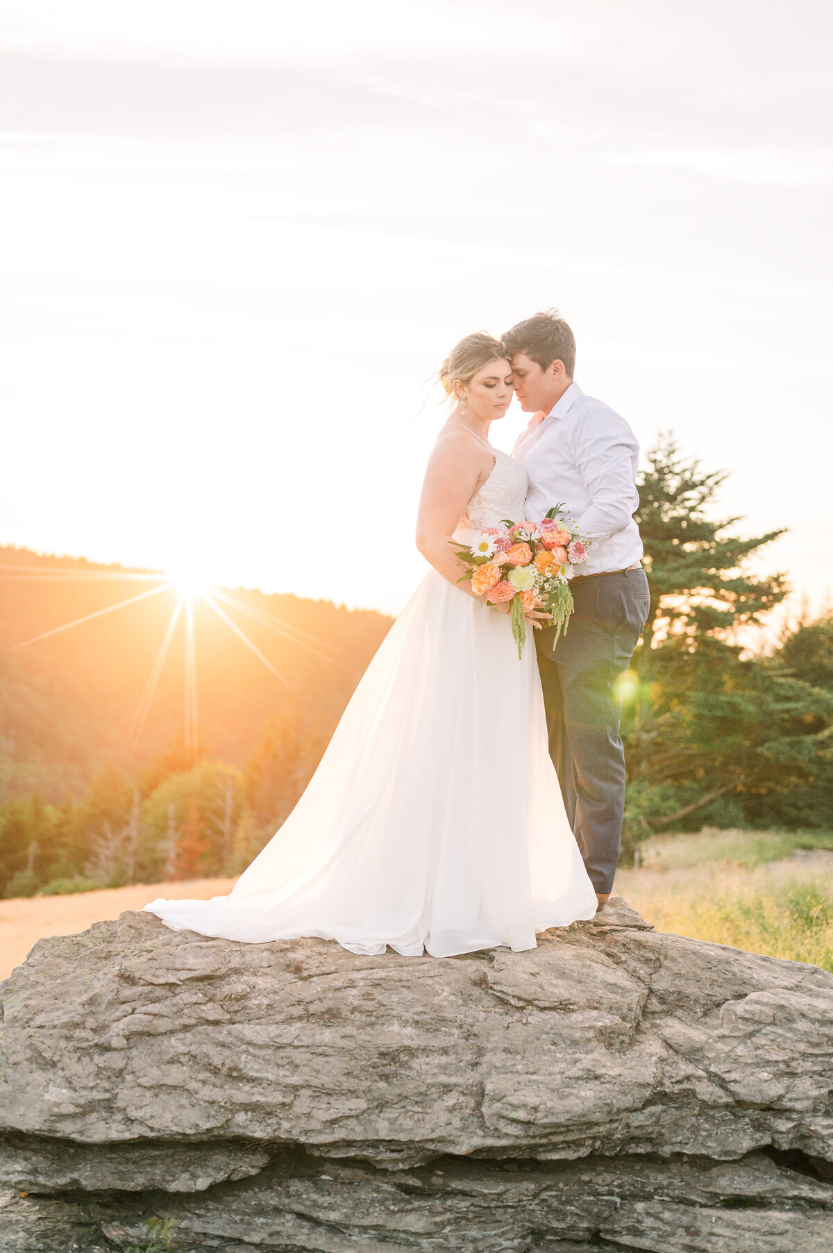 A couple on their elopement at sunset in the Blue Ridge Mountains by JoLynn Photography, a North Carolina wedding photographer