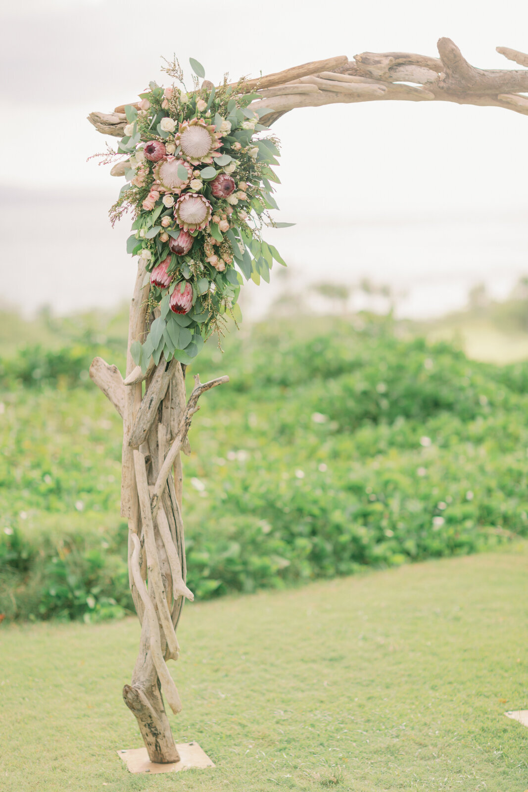 hawaiian florals on an arch in maui overlooking the ocean