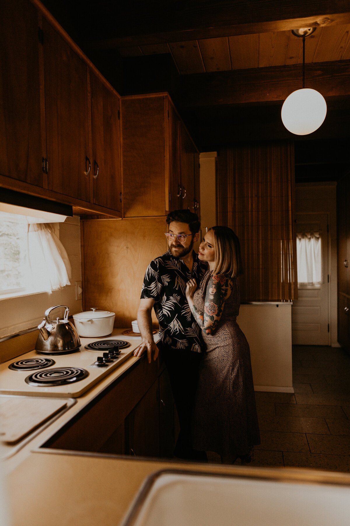 engaged couple hanging out in midcentury modern kitchen