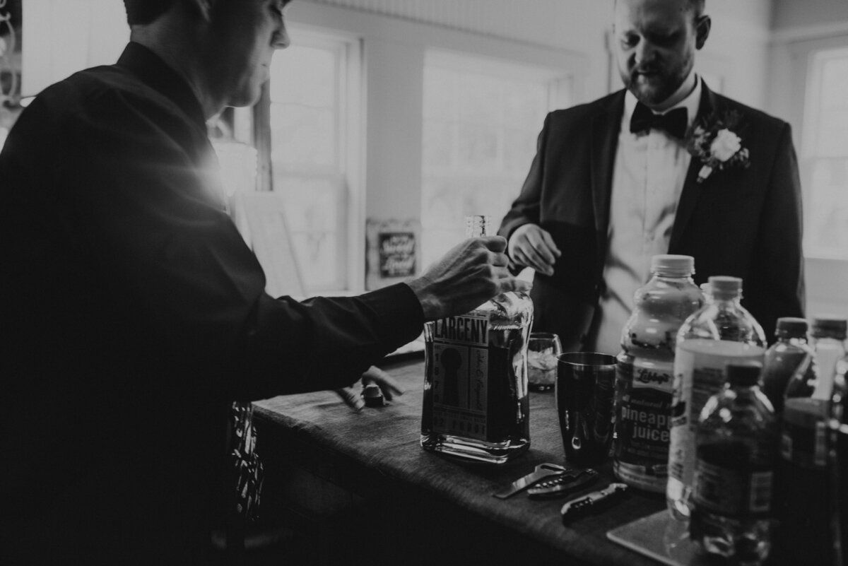 A man pours a groom a drink