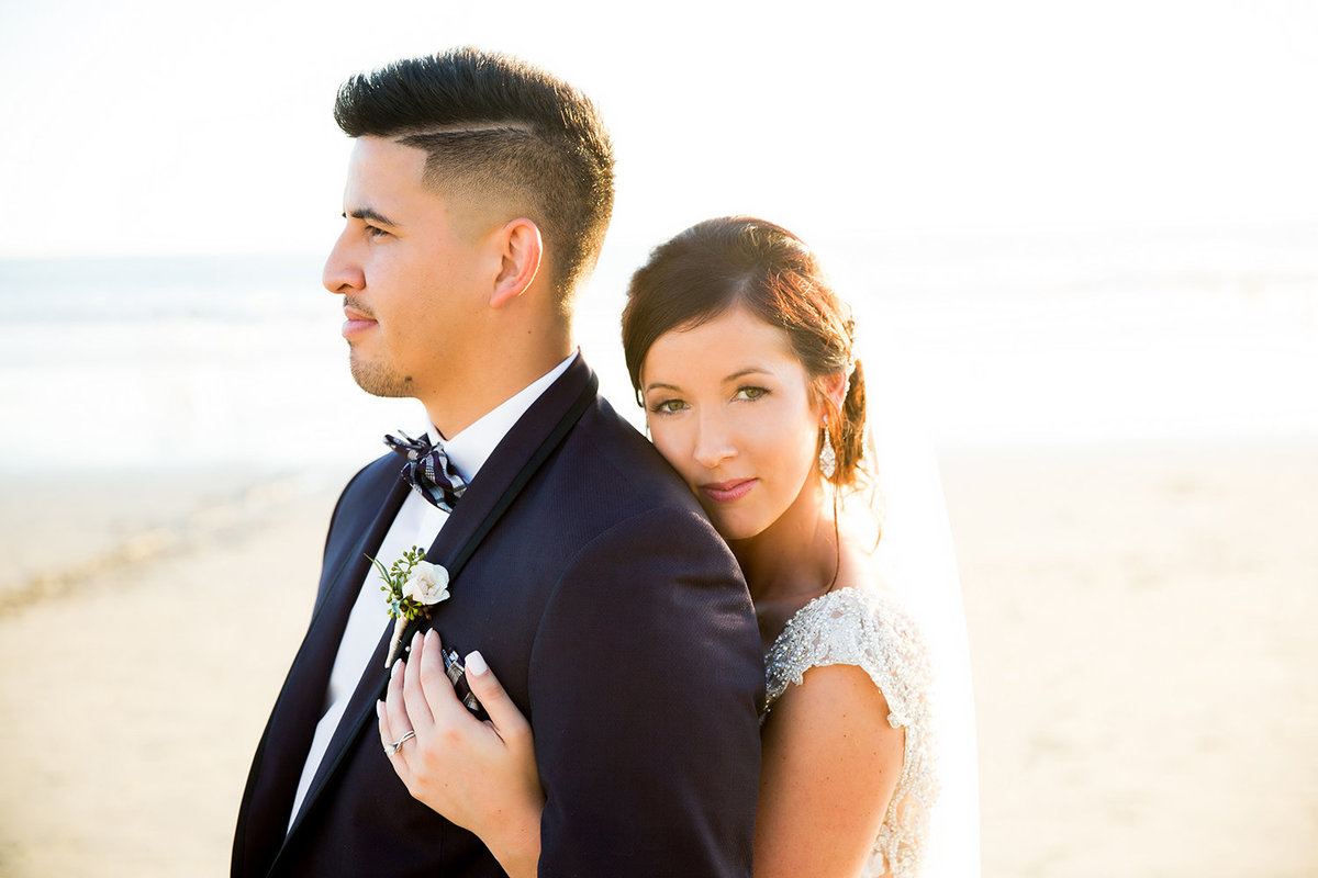 Wedding Couple Embracing at Beach  During Sunset