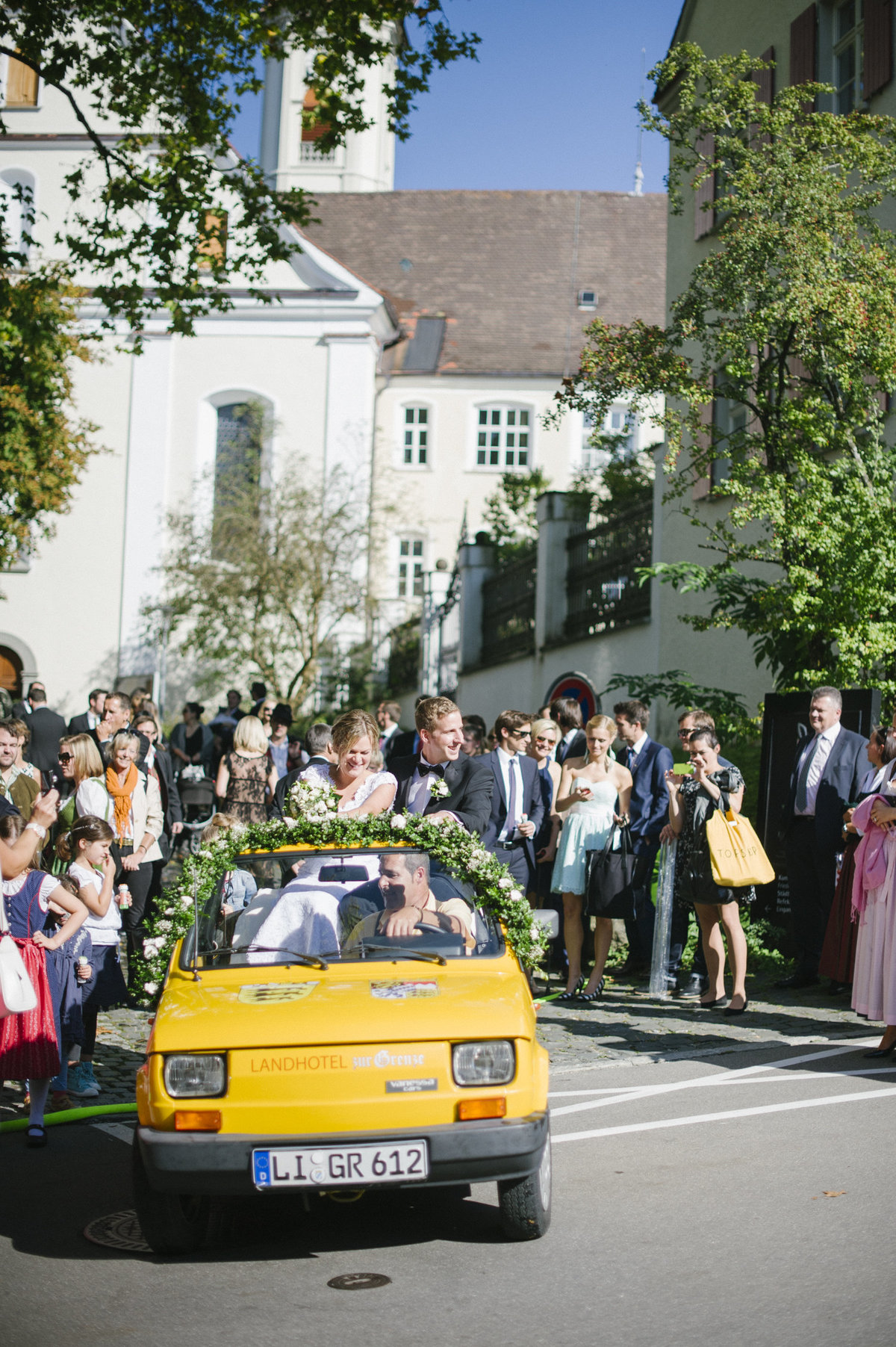 bride and groom greeting wedding guests isny town bavaria after church ceremony