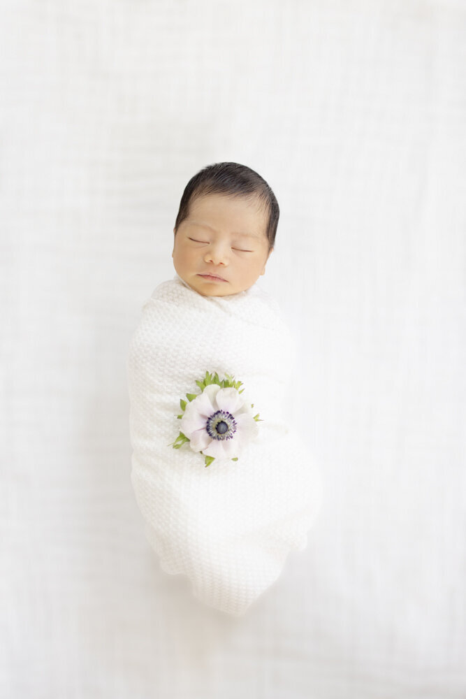 baby boy in white swaddle