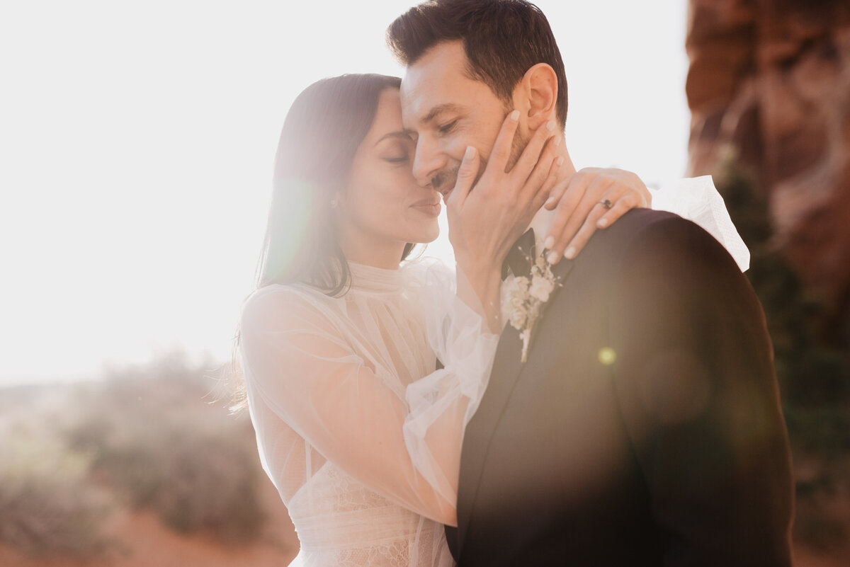 Utah elopement photographer captures bride holding groom's face during portraits