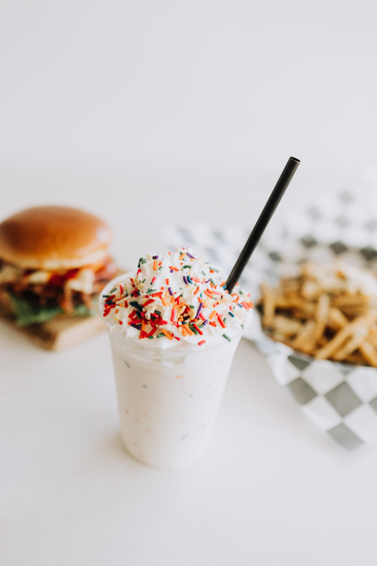 milkshake with burger and fries on white background