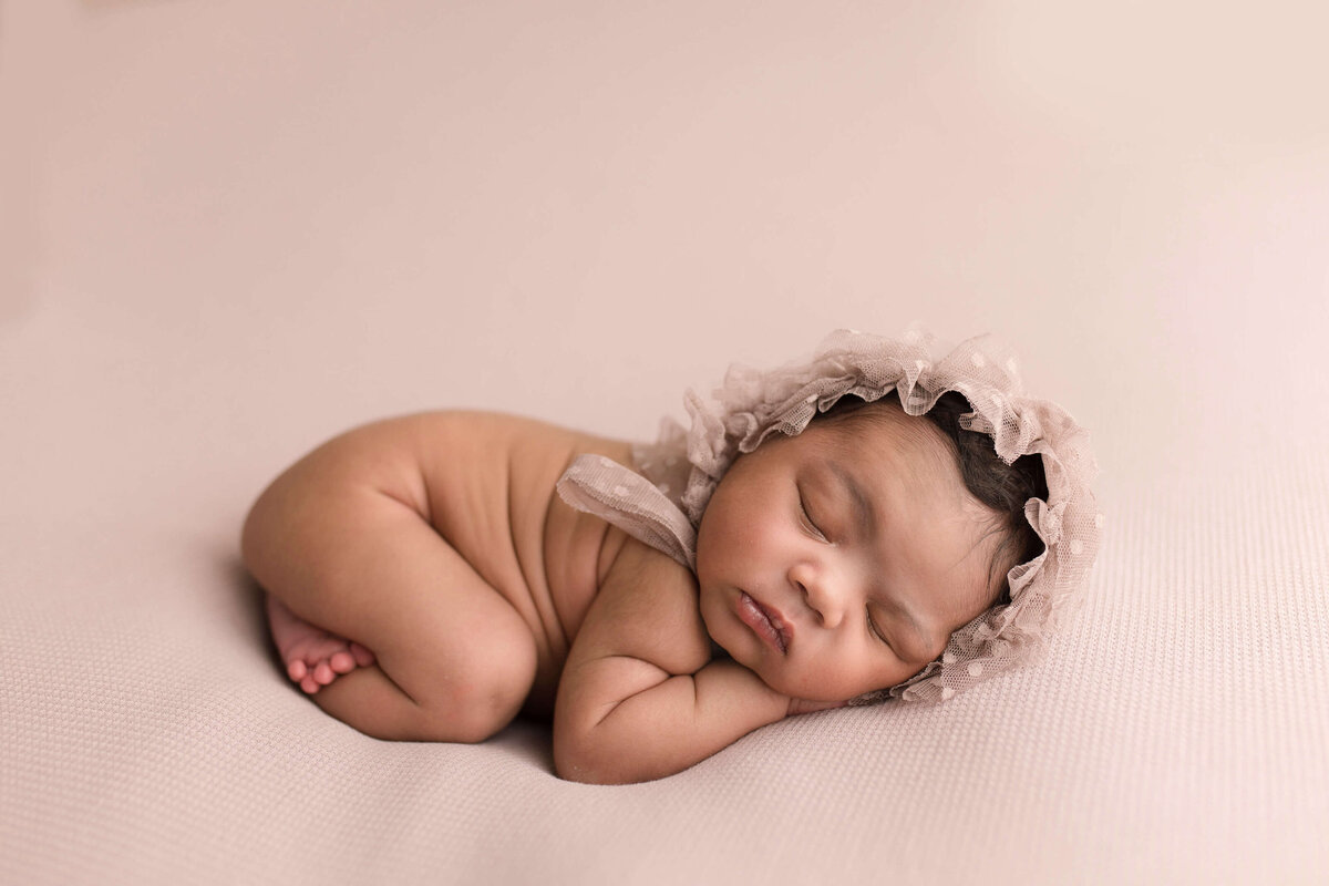 Baby girl with  lace bonnet sleeping