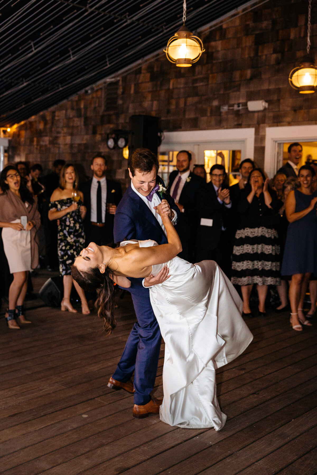 A groom dipping his bride during their first dance.