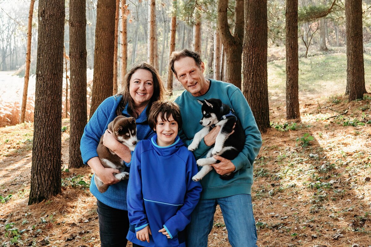 Family holding husky puppies McKennaPattersonPhotography