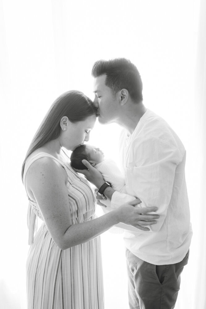 black and white portrait of parents with baby boy