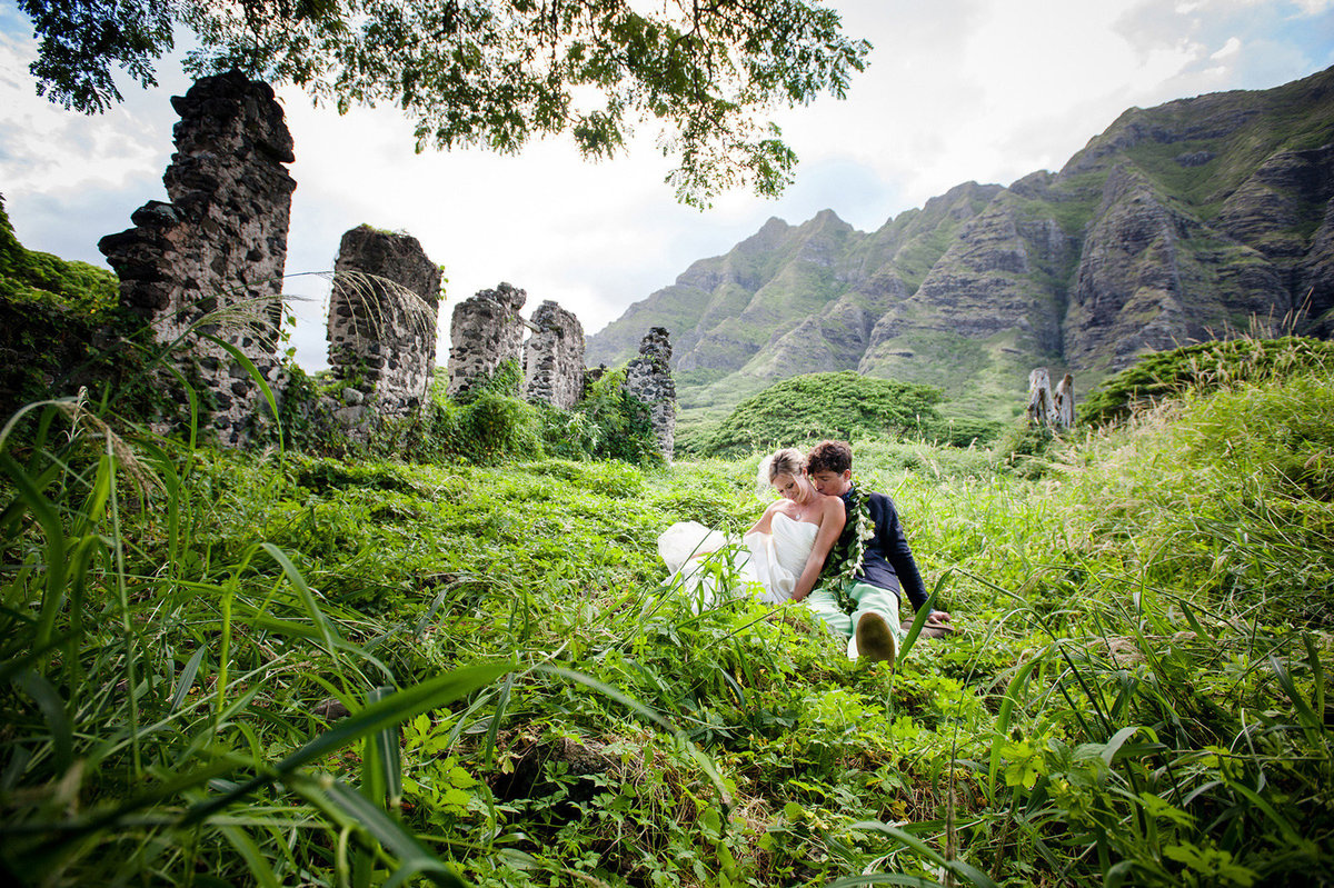 Bride and groom in grassy field
