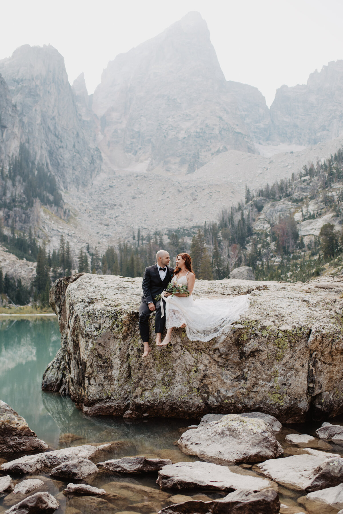 Jackson Hole photographers capture couple sitting on rock at Jenny Lake