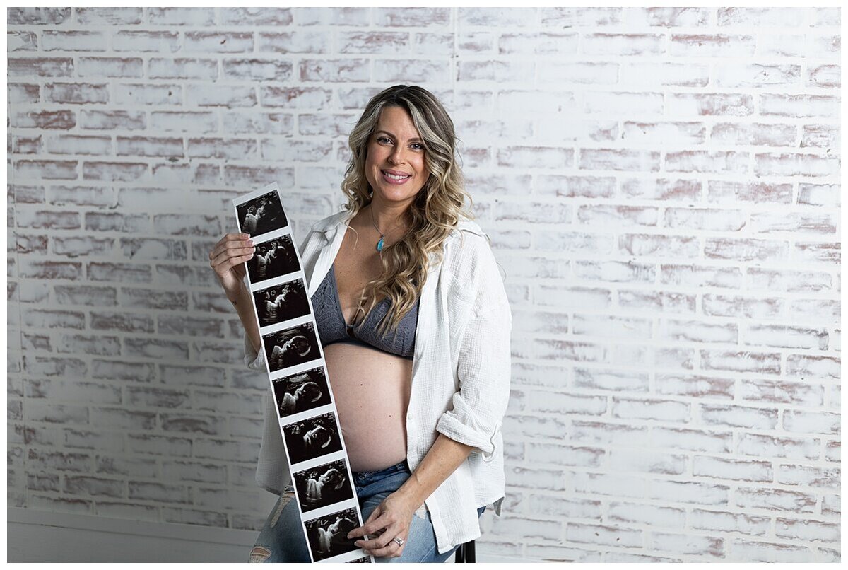 Mom to be showing off her beautiful baby bump in a cute top and jeans during a maternity photoshoot in studio in Wexford PA
