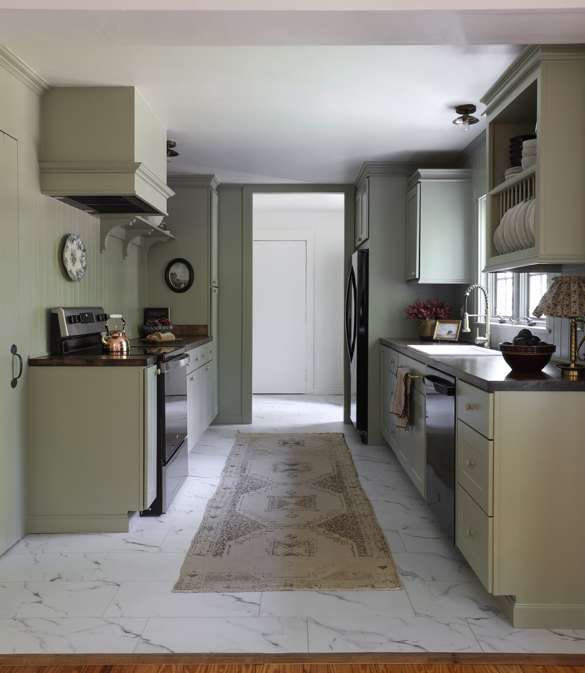 Moody Rustic Laundry Room renovation by Nadine Stay | Dark wood stained walls. Brown painted doors. DIY Ikea Pax hack. DIY mudroom built in cabinet. DIY shaker cabinet doors. DIY inset drawers. Basketweave brick floors.