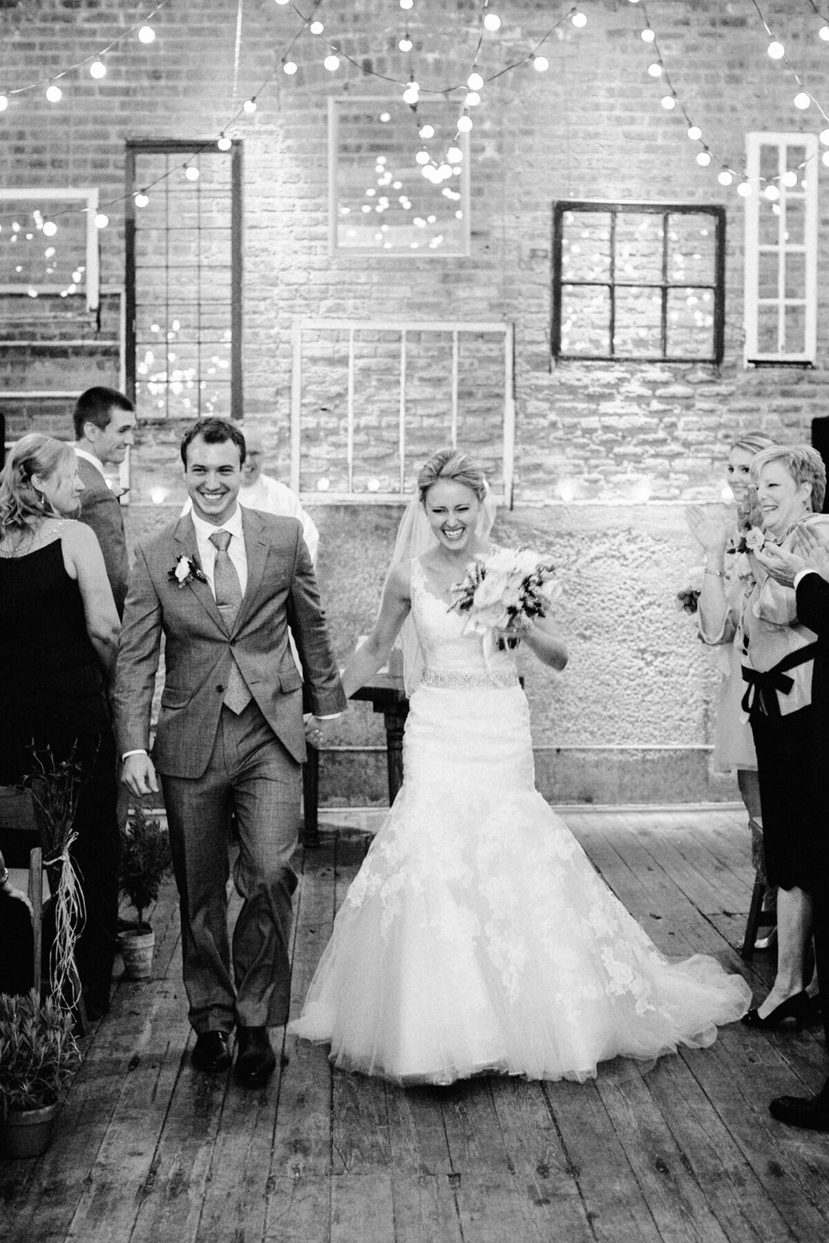 A black and white photo captured at the end of a wedding ceremony at Gallery 1028 in Chicago