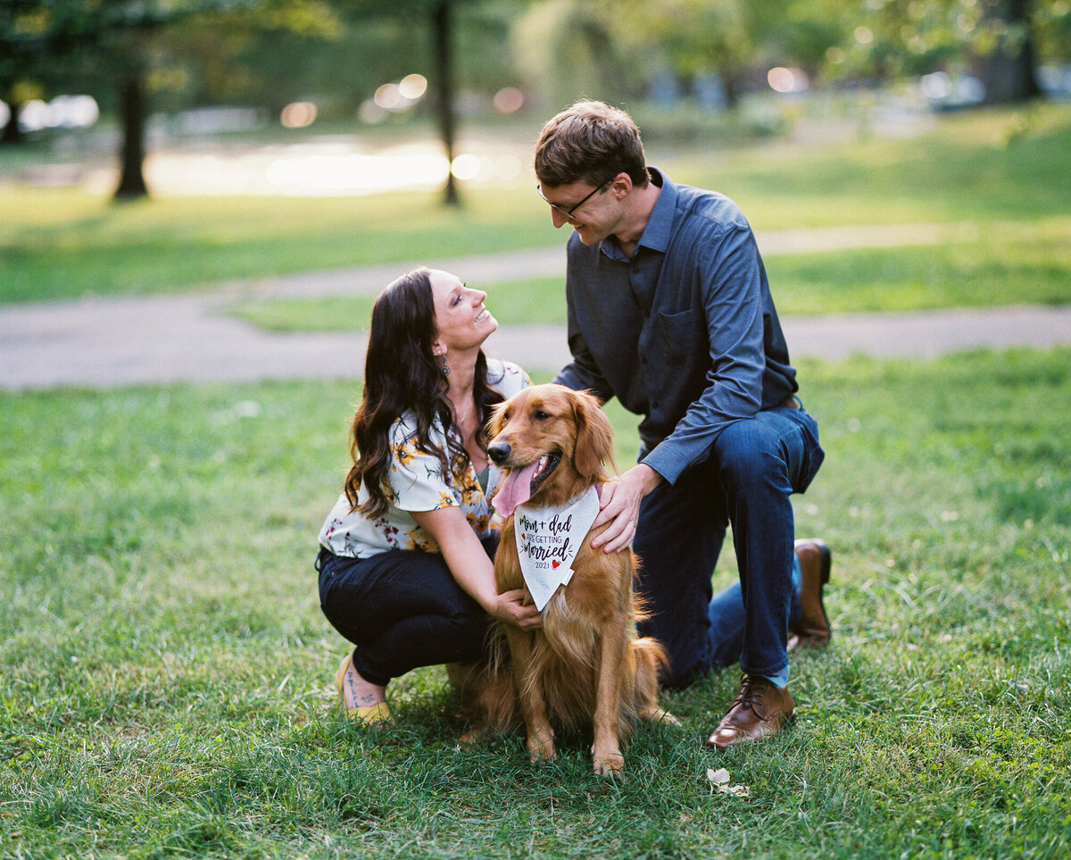 Couple poses with their dog during their engagement session in German Village