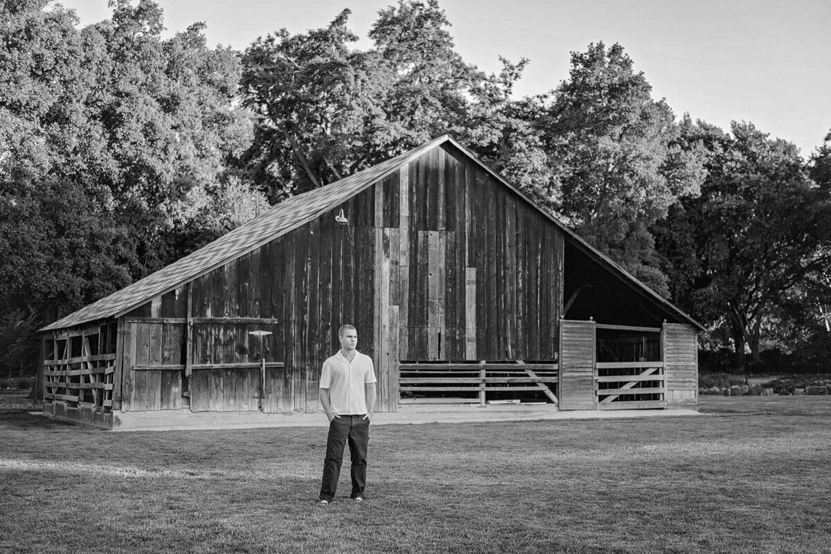 Black and white senior guy photos with an old barn in Dublin, CA