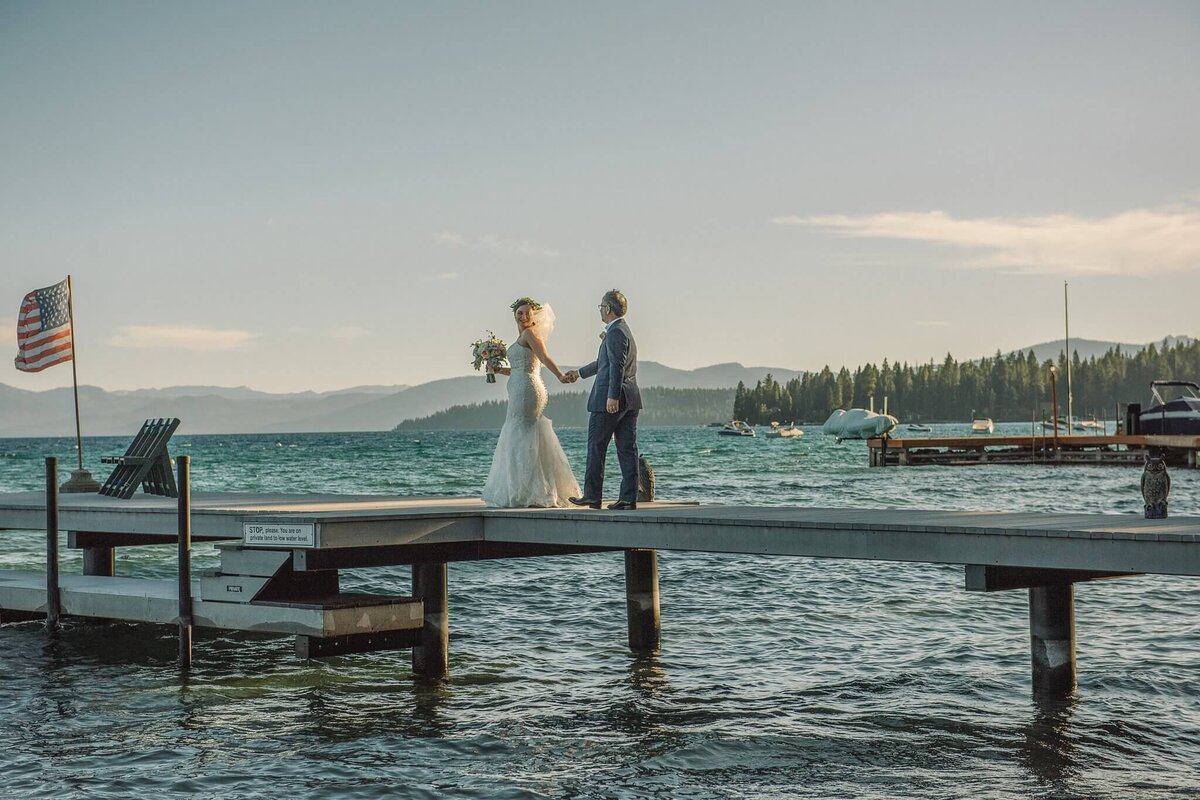 newlyweds on pier in Lake tahoe