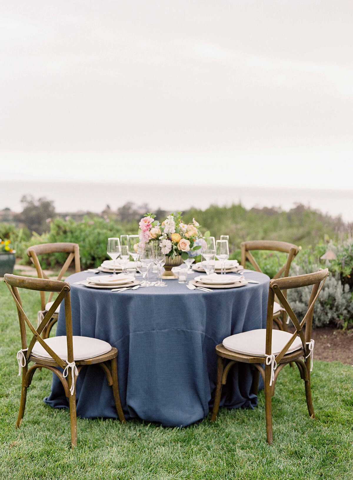 20santa-barbara-estate-wedding-planner-wood-x-back-chairs-ocean-front-reception-table