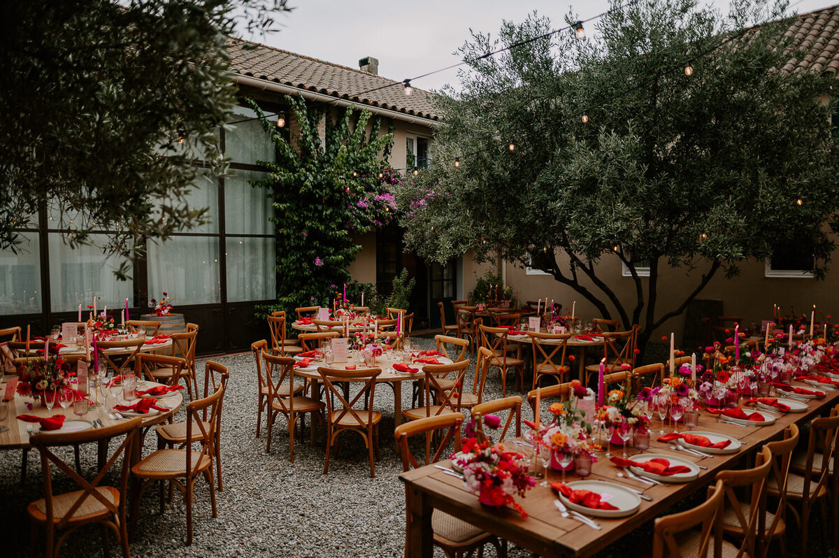Chateau Canet's courtyard was filled with trestle tables with pink and orange flowers and candles that matched with pink napkins which really brought some colour to this southern French wedding venue.