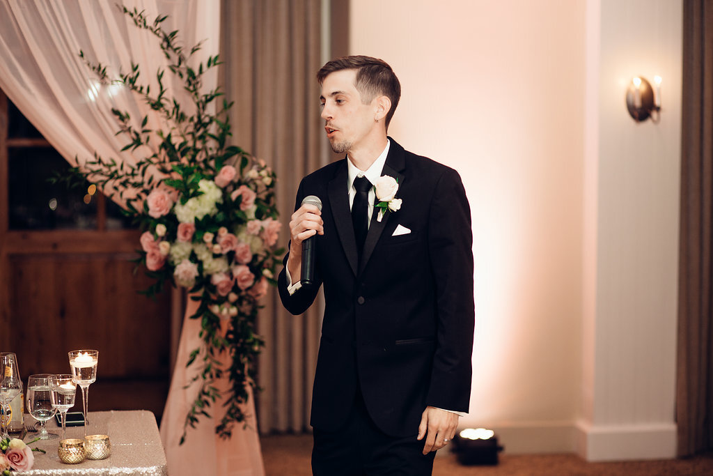 Wedding Photograph Of Groom In Black Suit Speaking In The Microphone Los Angeles