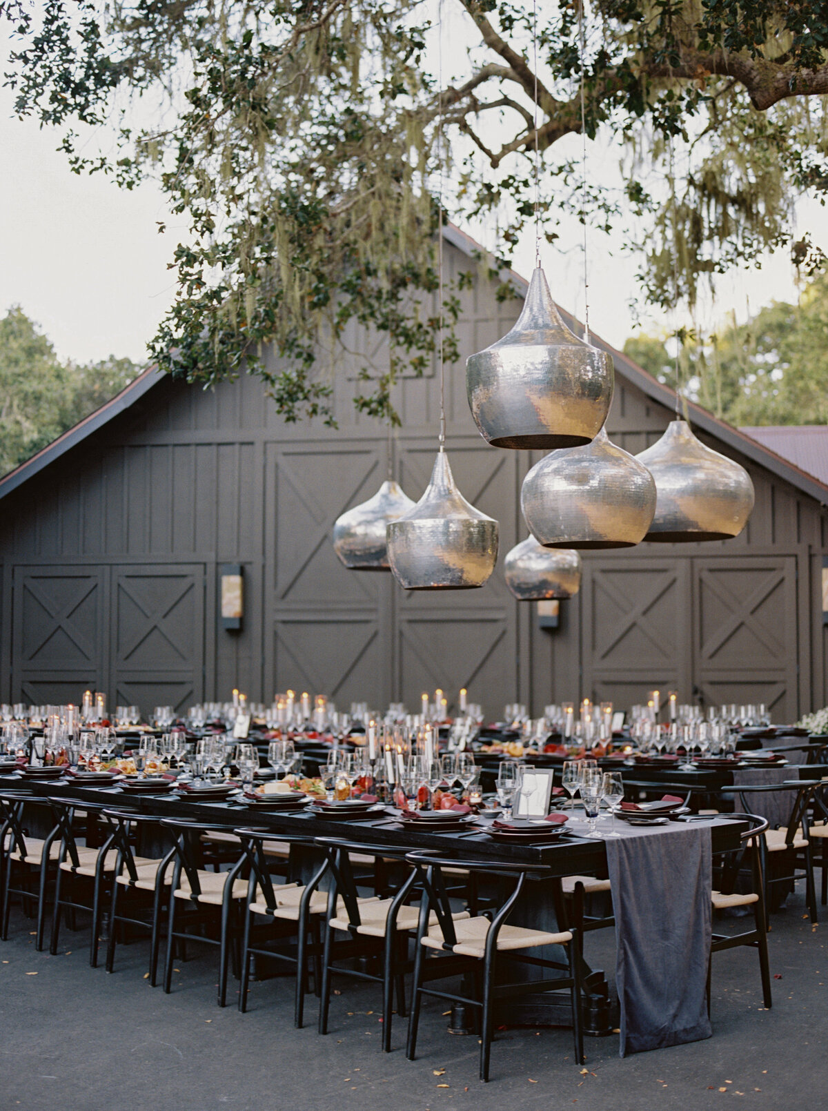 Long  Dinner Tables with Hanging Lighting at Private Home at the Preserve