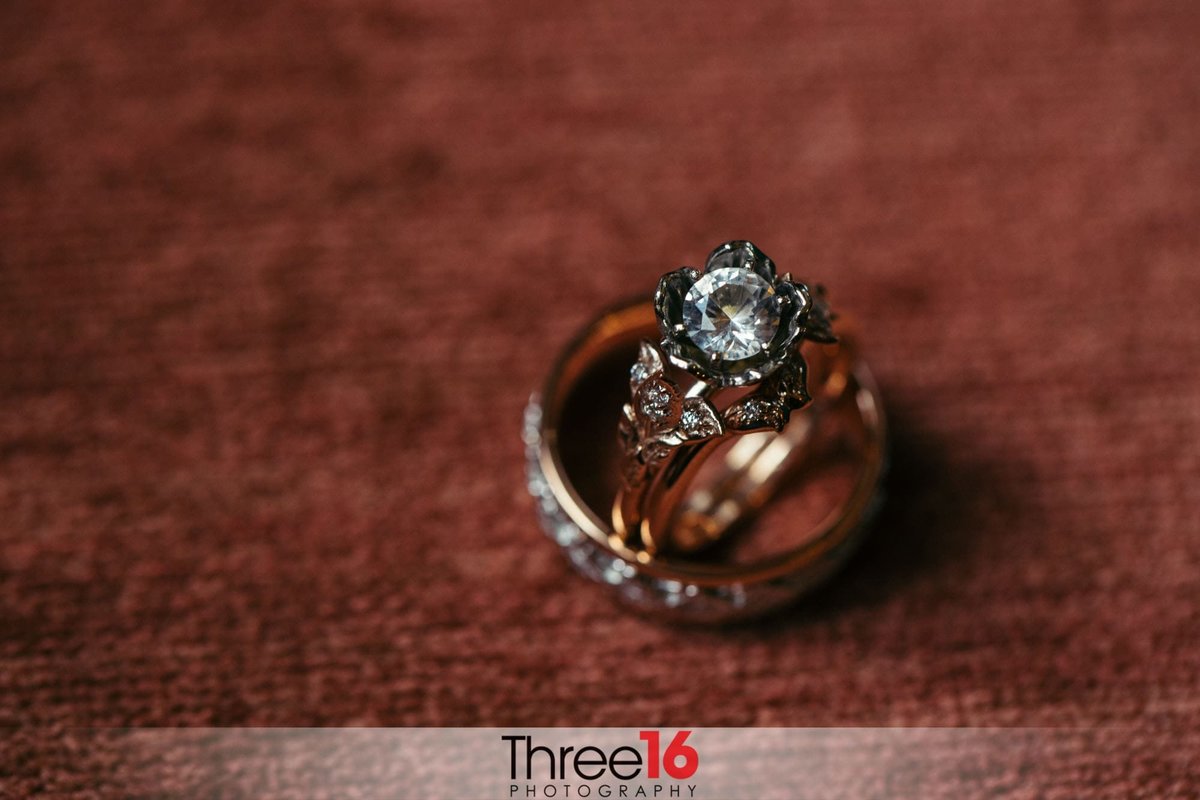 Brides engagement ring sits inside her wedding band