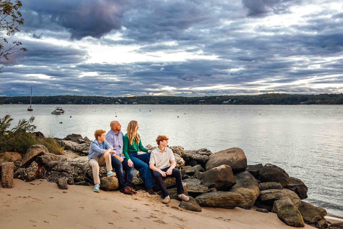 family sitting on rocks long island photographer