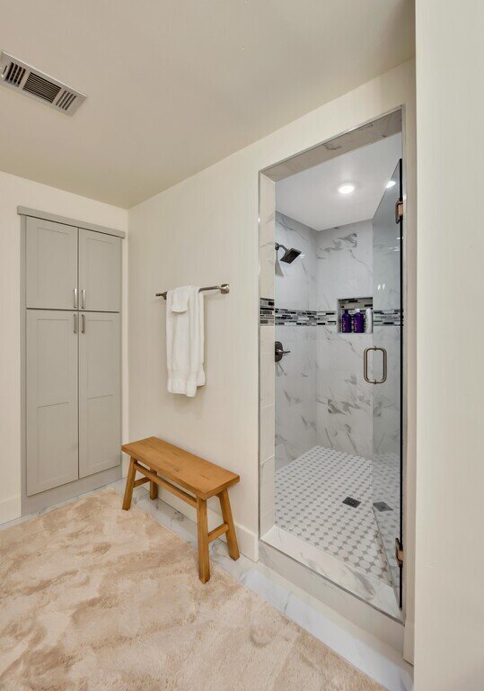 Bathroom with large shower and additional storage int his 2 bedroom, 2.5 bathroom luxury vacation rental loft condo for 8 guests with incredible downtown views, free parking, free wifi and professional decor in downtown Waco, TX.