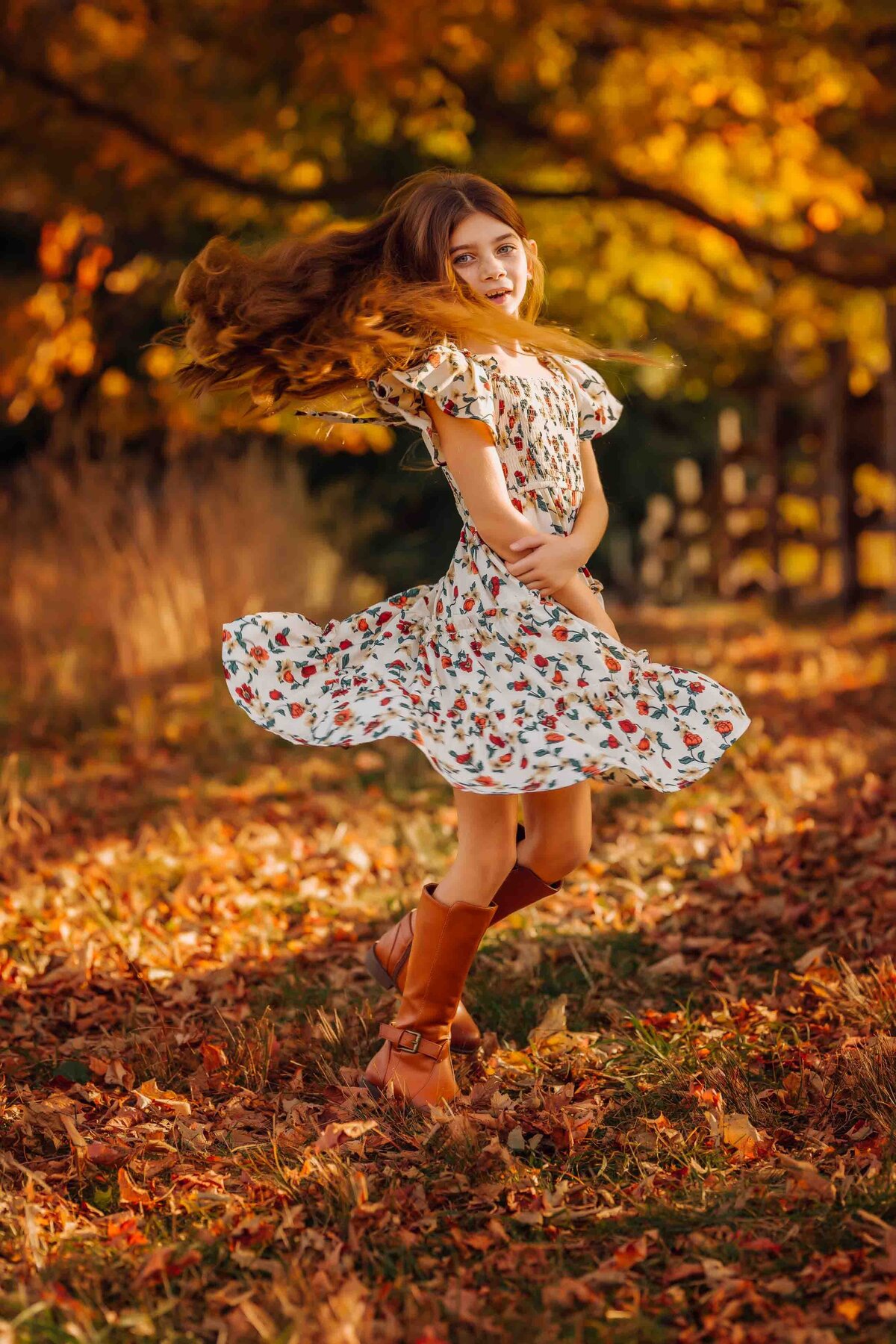 girl spinning in fall foliage