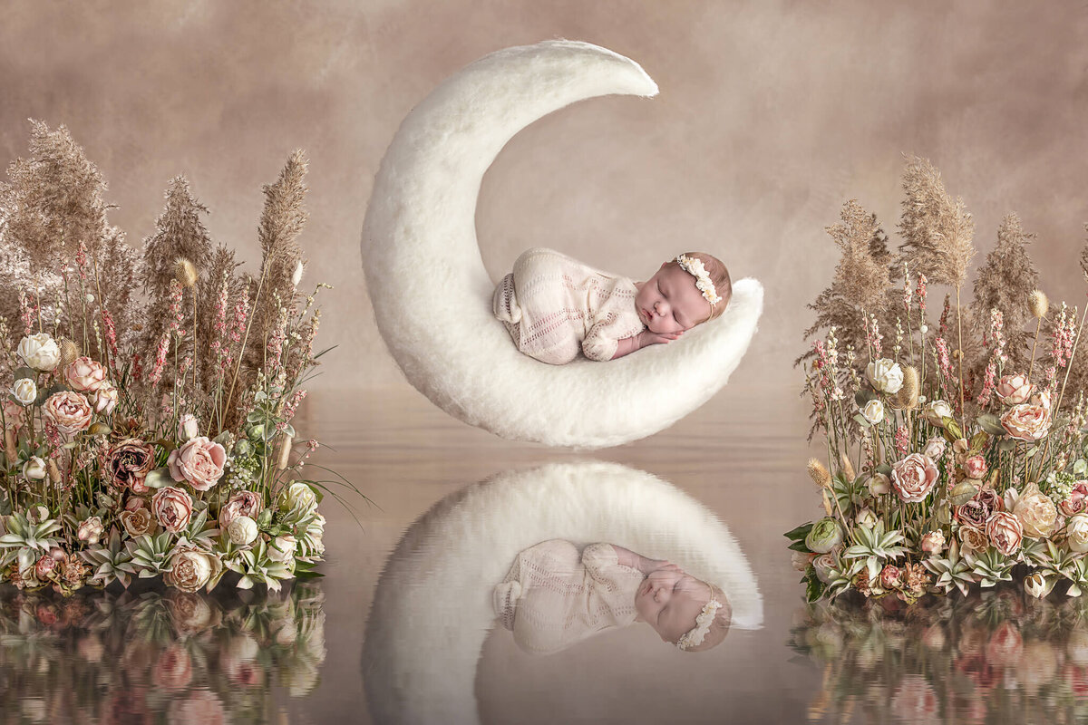 Akron ohio newborn photographer with newborn baby girl on moon.