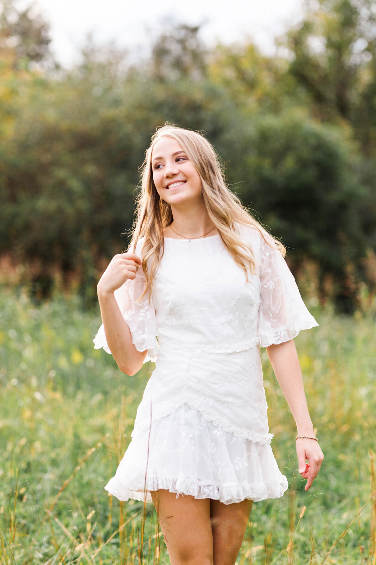 high school senior walking in a field for photos in Cleveland, TN