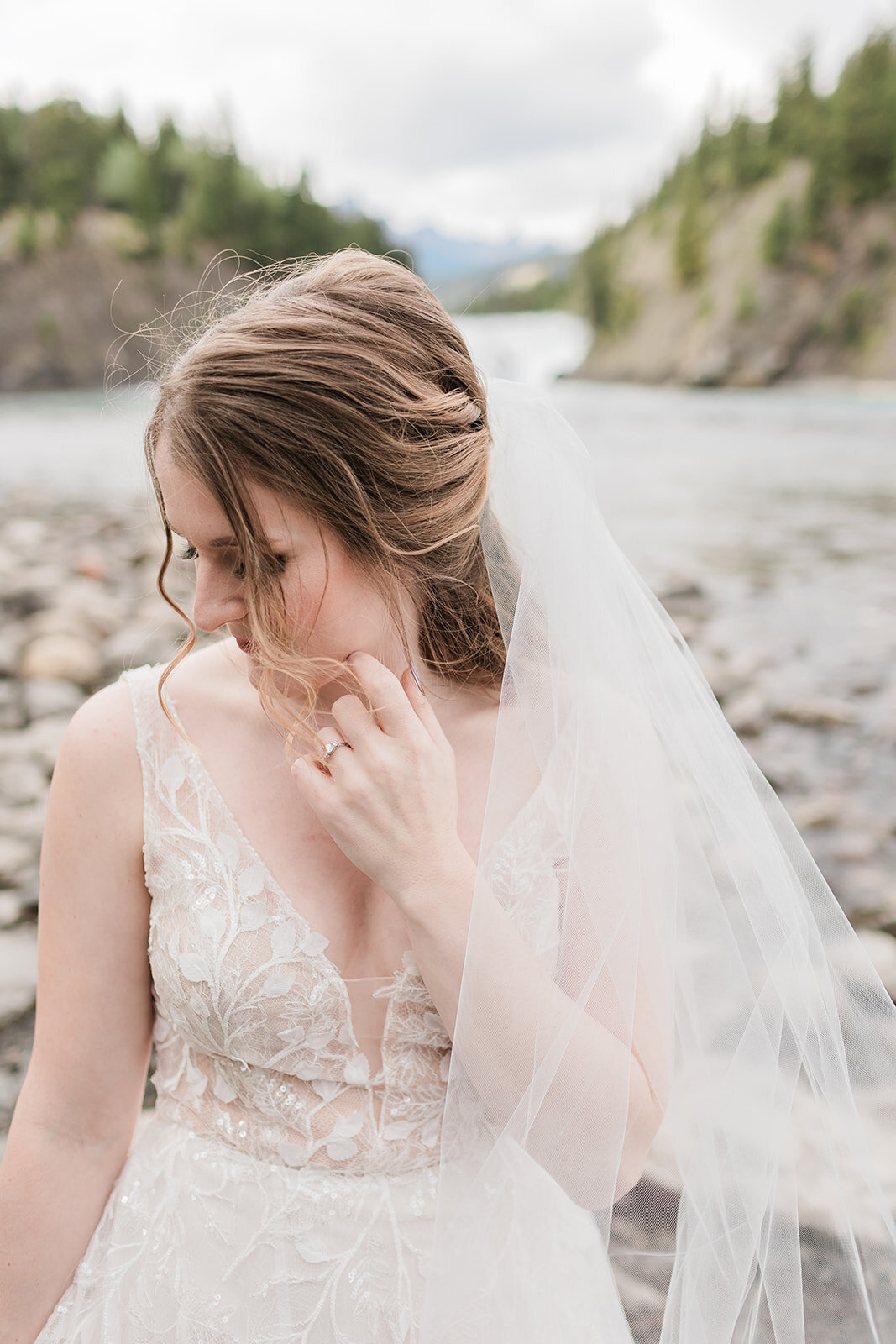 Bridal portrait on pebble beach in Banff Alberta