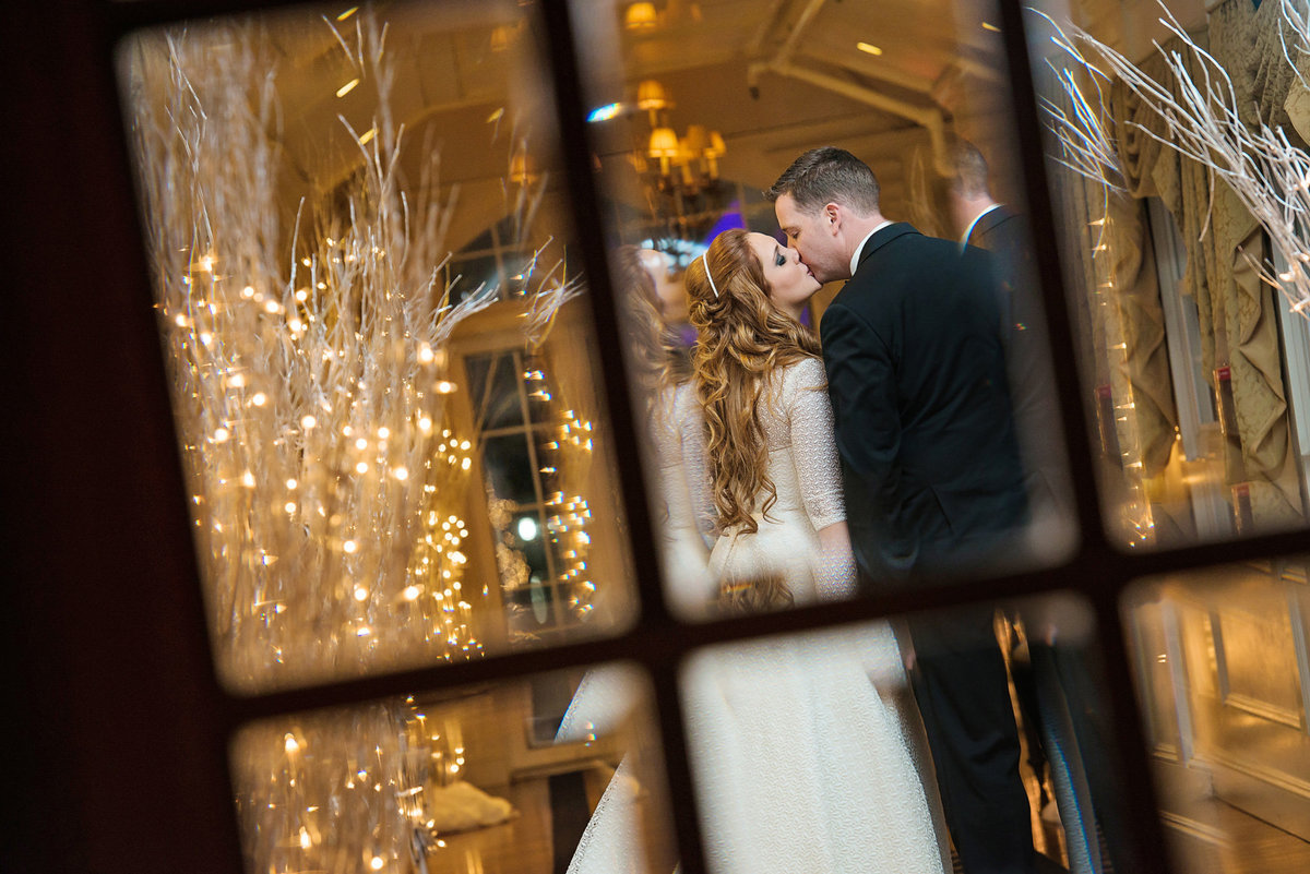 Bride and groom kissing at the hallway of Bridgeview Yacht Club