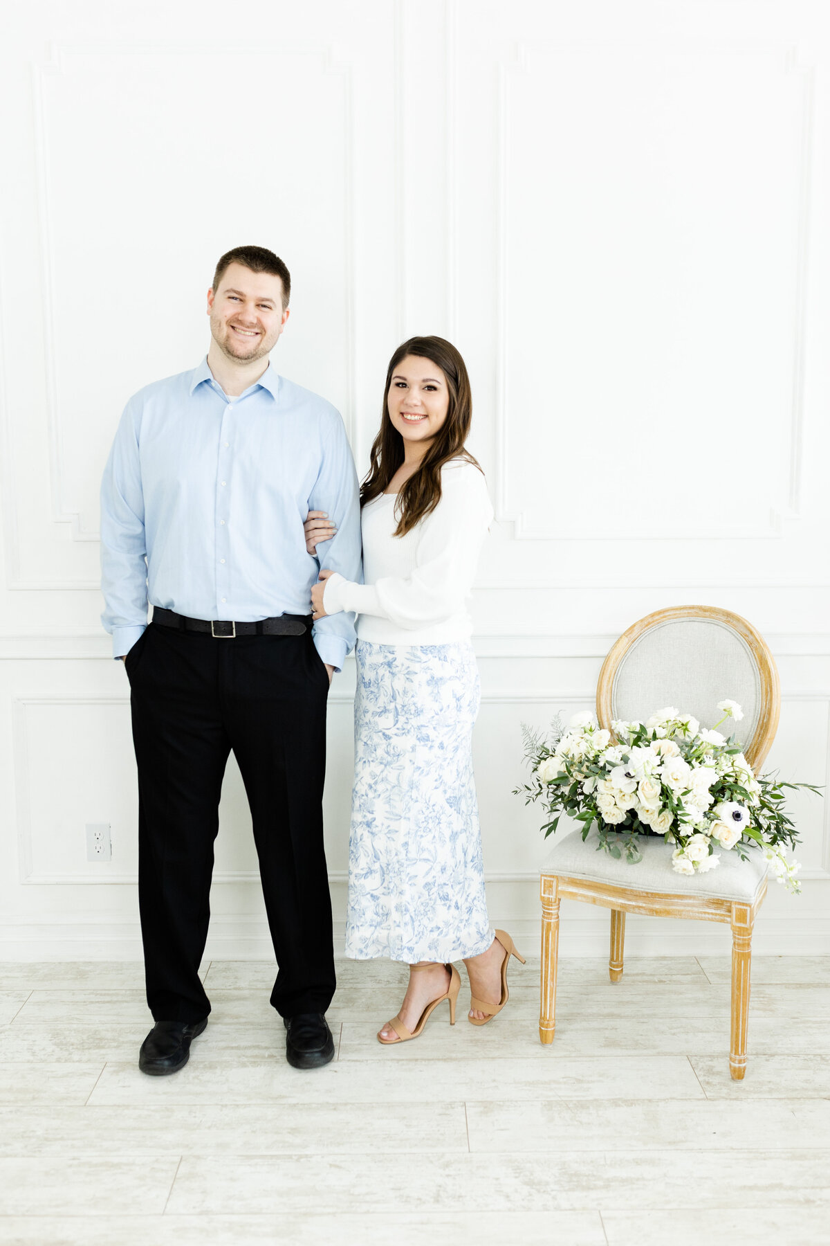 wedding photographers posing with flowers for brand