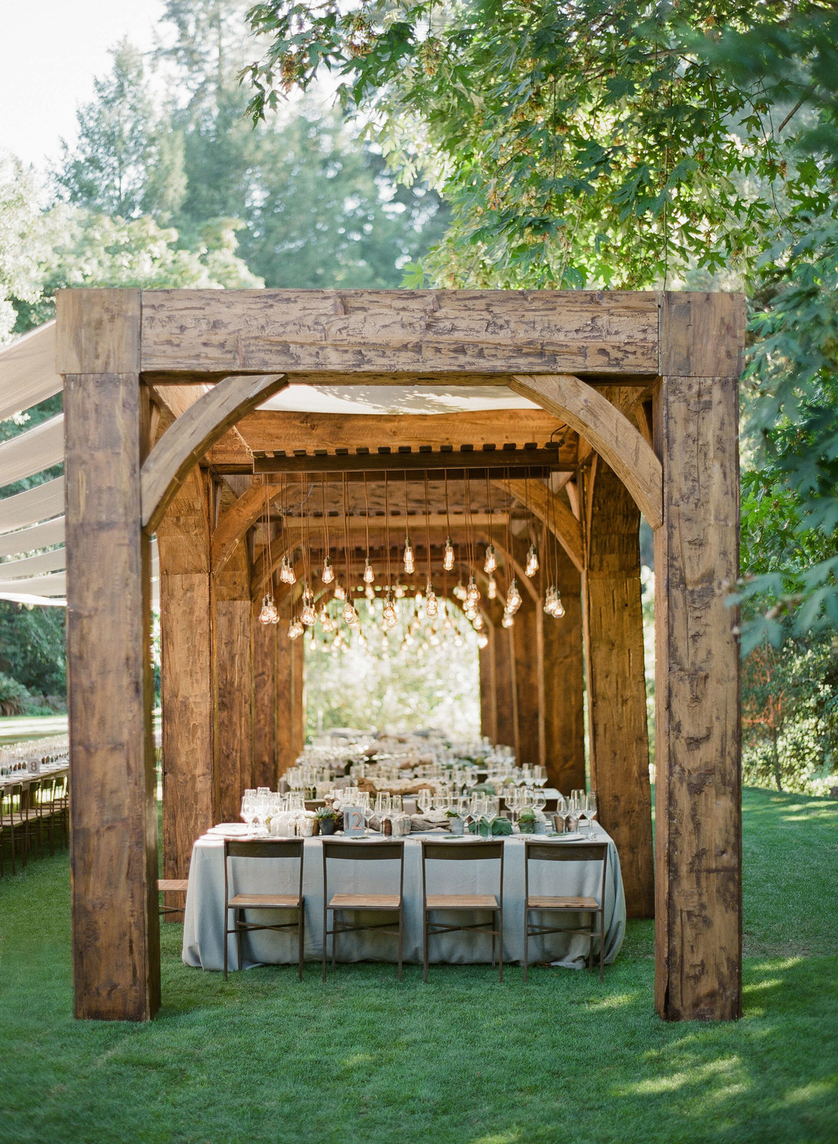 54-KTMerry-wedding-reception-wooden-arbor-NapaValley
