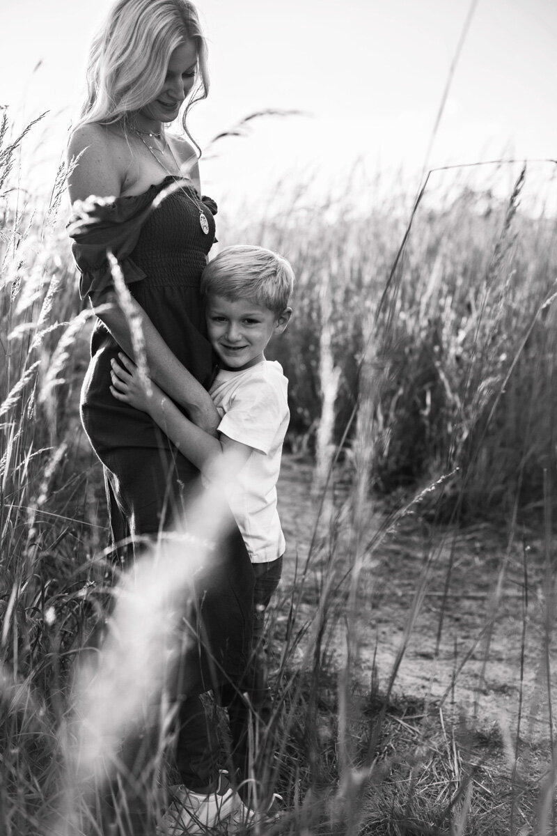 Mother and son in a field with tall grass