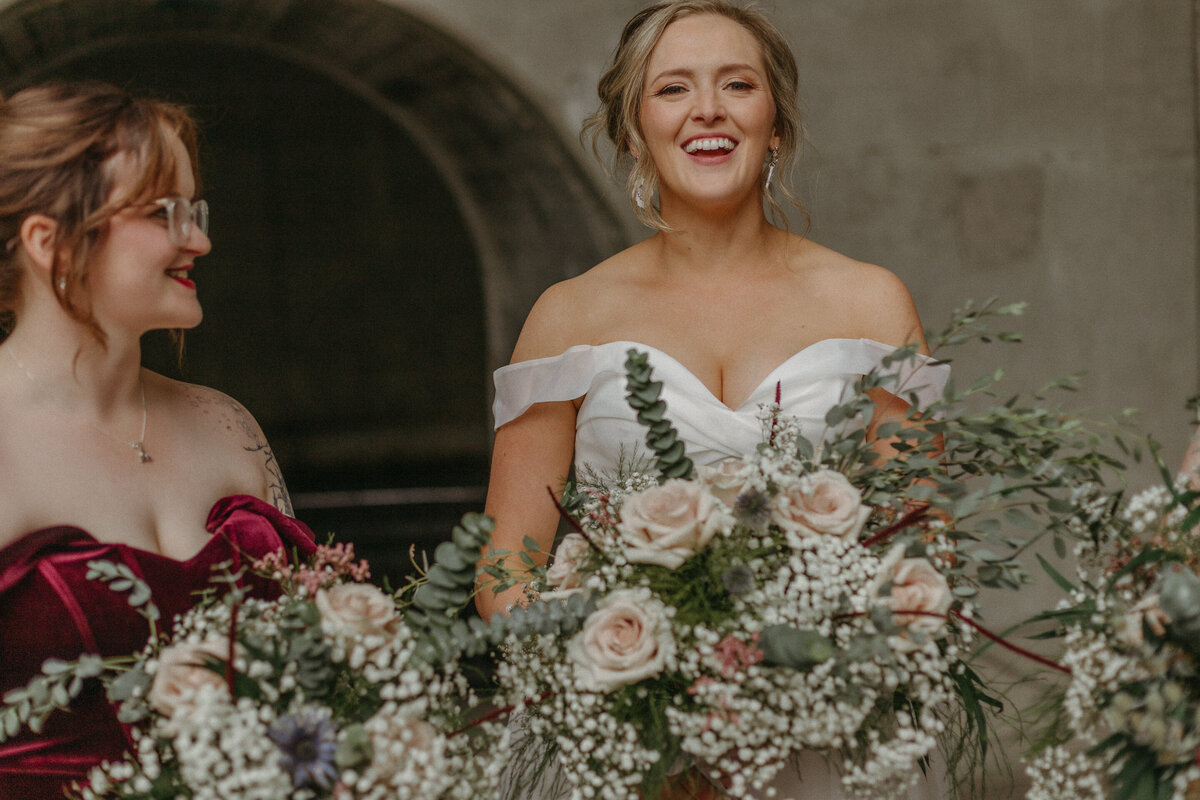 Bride and bridesmaids laughing during wedding photos downtown Ottawa